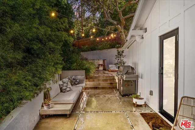 a view of a backyard with sitting area
