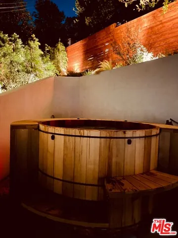 a view of jacuzzi with large tree