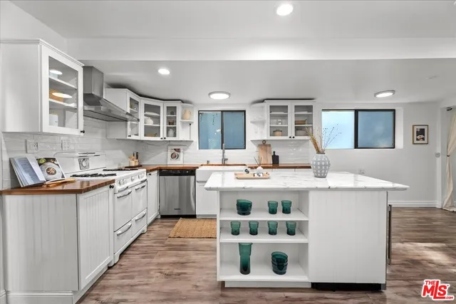 a kitchen with kitchen island granite countertop a sink and cabinets