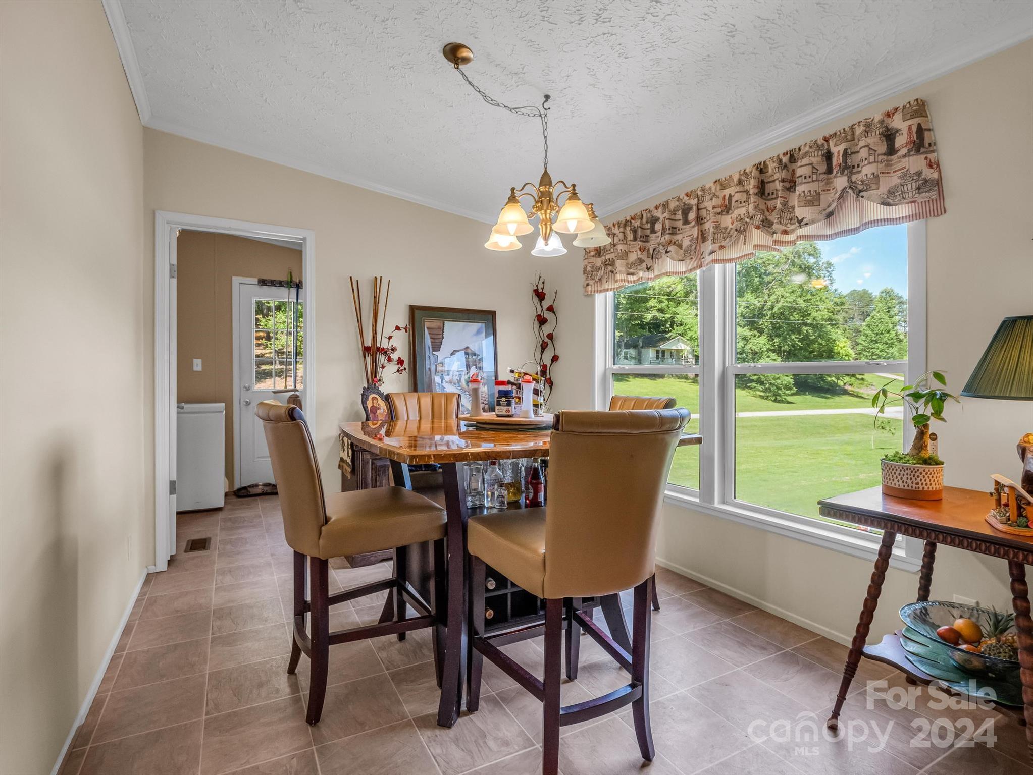 202 Mogene Road Rutherfordton, NC 28139 - Photo 25 of 40 a dining room with furniture a chandelier and wooden floor