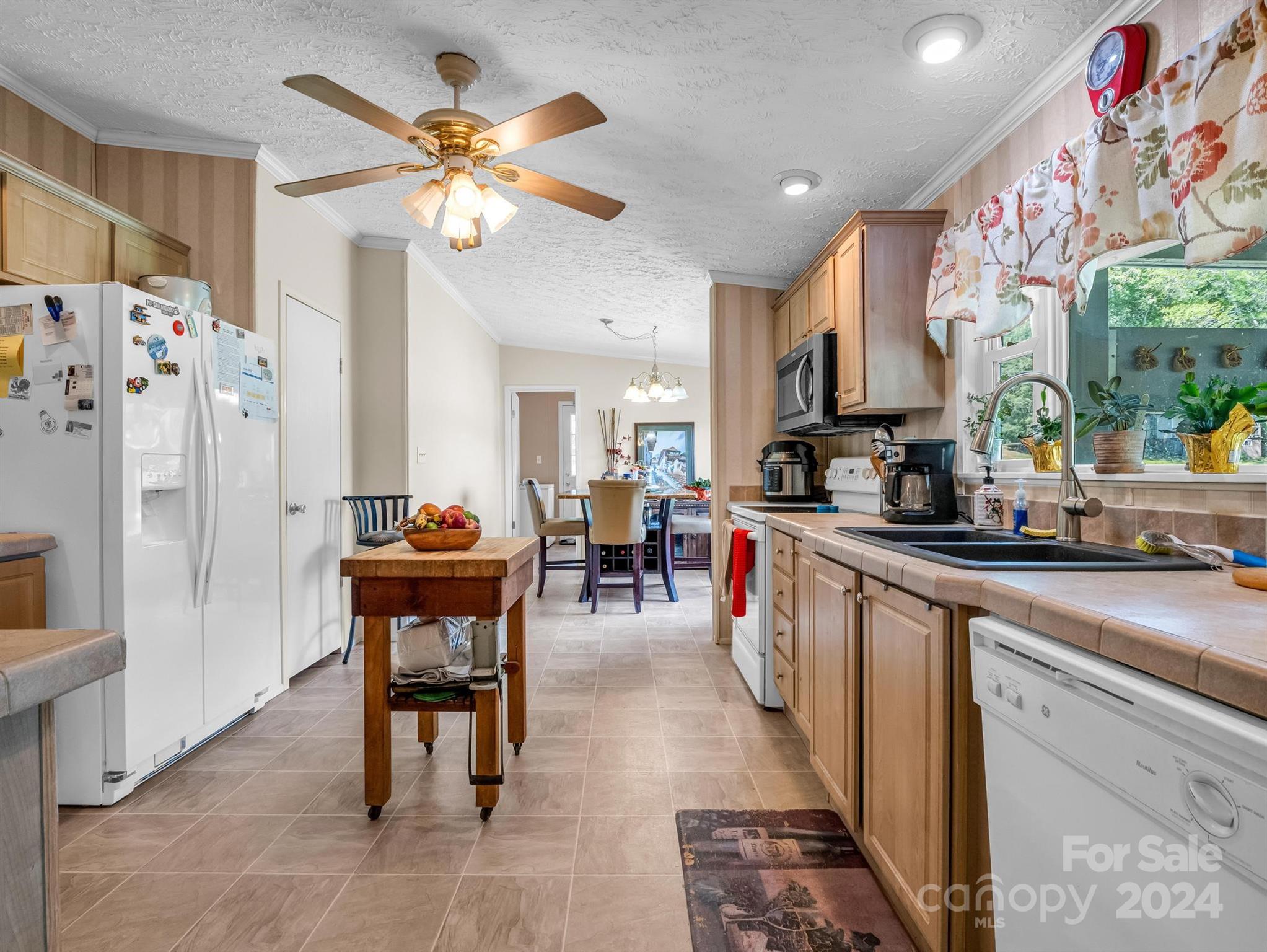202 Mogene Road Rutherfordton, NC 28139 - Photo 27 of 40 a kitchen with stainless steel appliances granite countertop a refrigerator a sink dishwasher a dining table and chairs with wooden floor