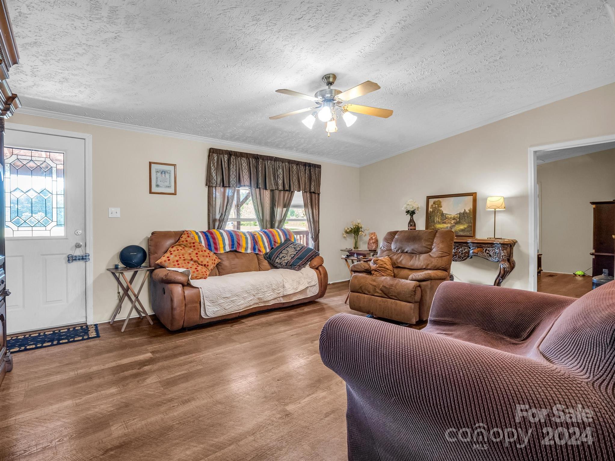 202 Mogene Road Rutherfordton, NC 28139 - Photo 32 of 40 a living room with furniture and a chandelier