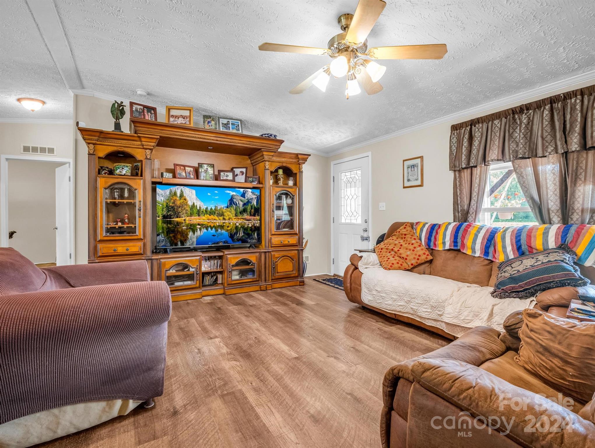 202 Mogene Road Rutherfordton, NC 28139 - Photo 33 of 40 a living room with furniture and a flat screen tv