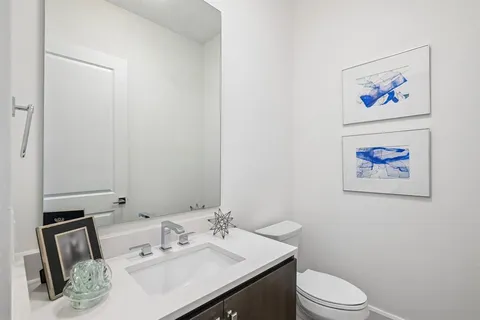 a bathroom with a sink a toilet and mirror