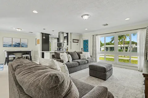 a view of a house with backyard and sitting area