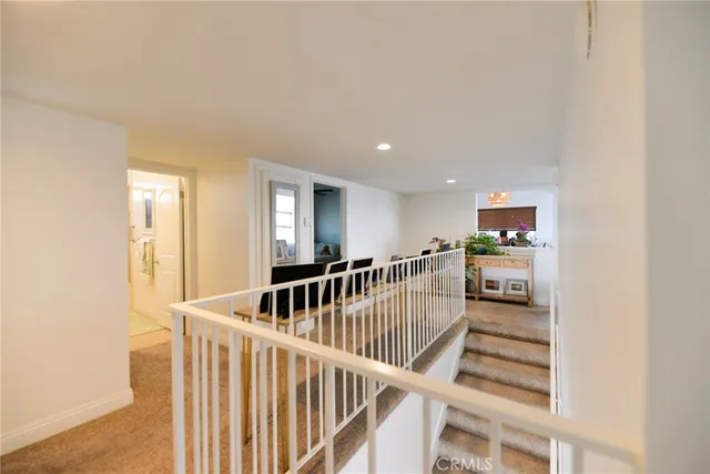 a bathroom with a granite countertop sink a toilet a mirror and shower