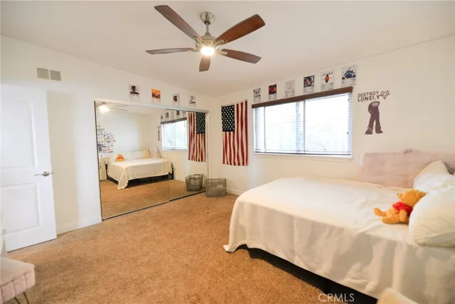 a kitchen with stainless steel appliances kitchen island granite countertop a table chairs and a refrigerator