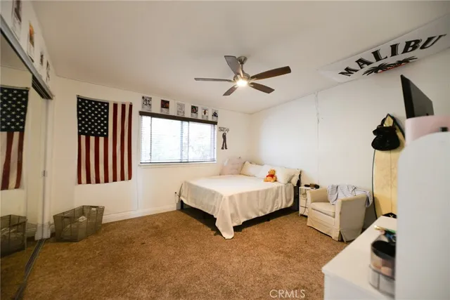 a kitchen with stainless steel appliances kitchen island granite countertop a refrigerator a sink dishwasher a stove and a dining table with wooden floor