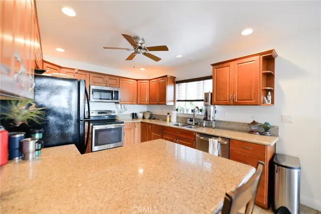 a view of a dining room and livingroom with furniture wooden floor a chandelier