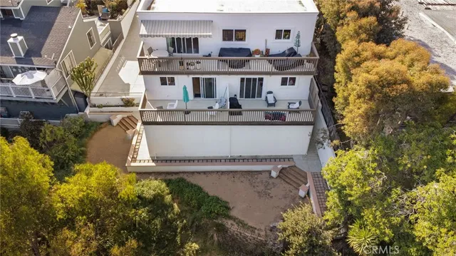 an aerial view of a house with a yard and balcony