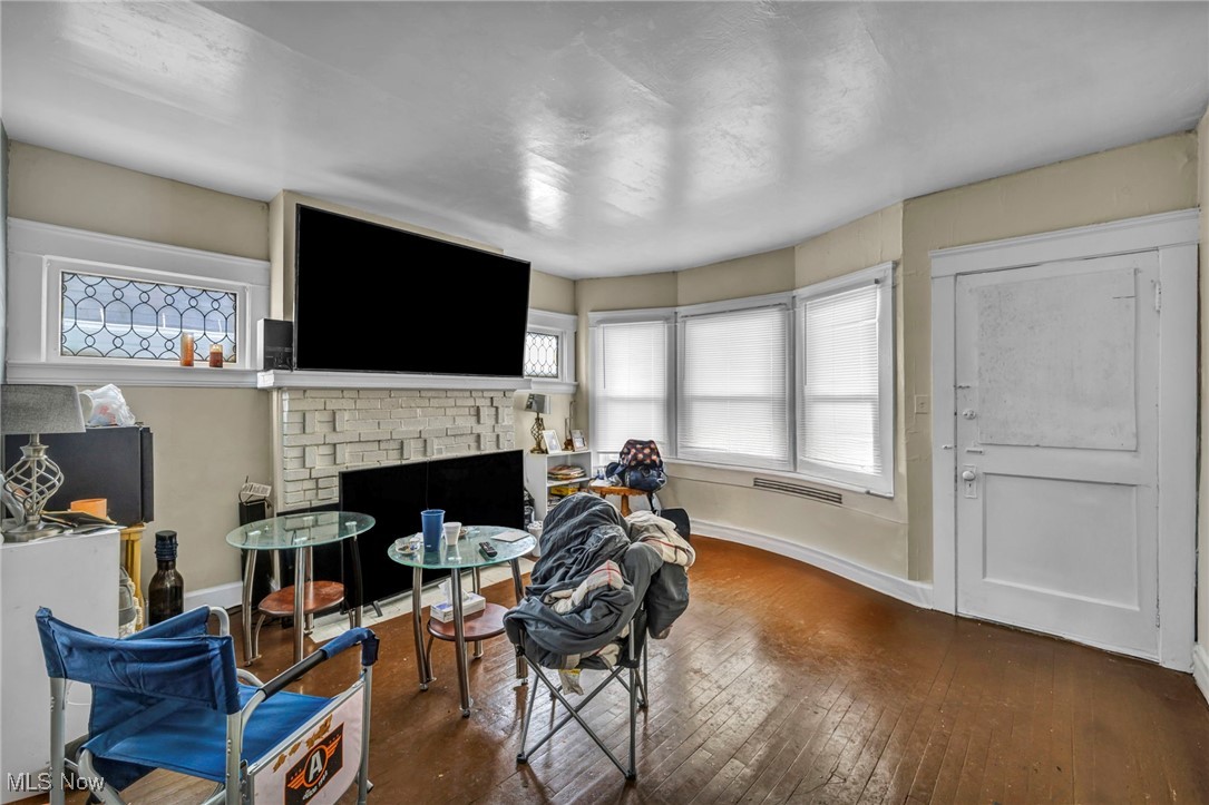 738 Eddy Road Cleveland, OH 44108 - Photo 10 of 33 Living area with healthy amount of natural light, wood-type flooring, and a fireplace