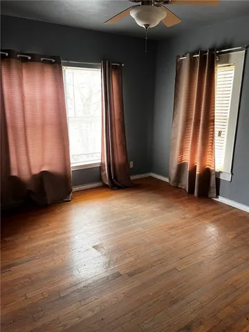 an empty room with windows and closet