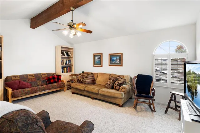 a living room with furniture and a ceiling fan