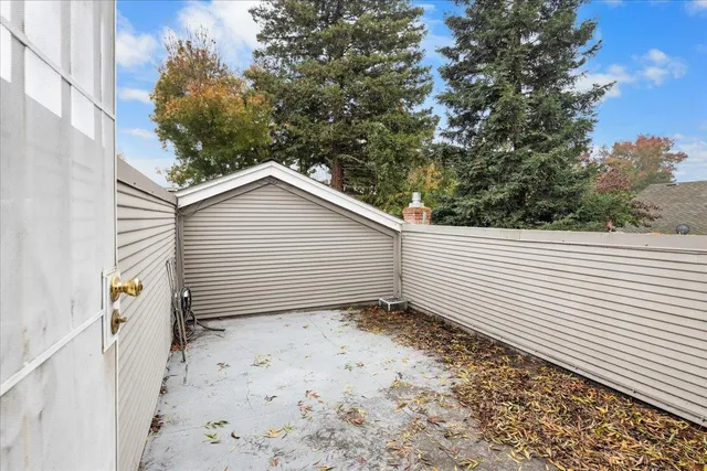 a kitchen with white cabinets a sink dishwasher and a stove with wooden floor