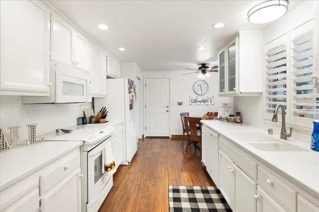 a spacious bathroom with a double vanity sink a mirror and a bathtub