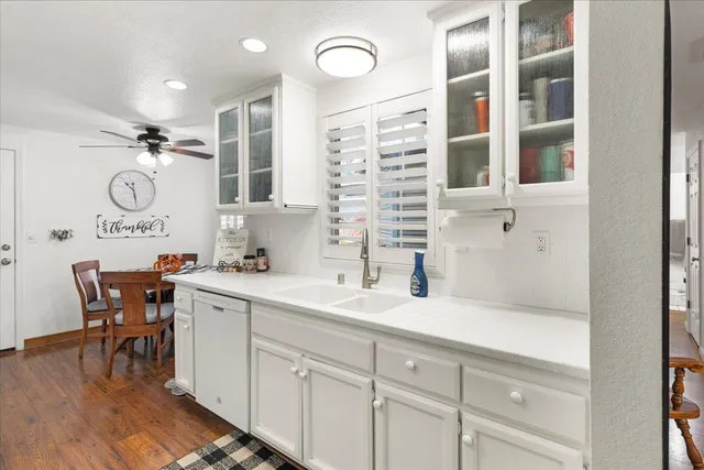 a kitchen with white cabinets and white appliances