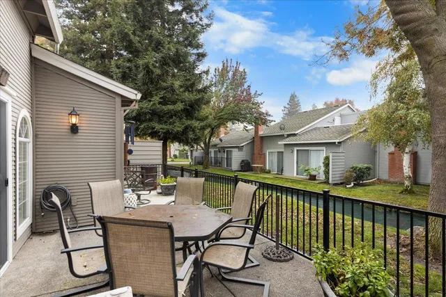 a view of a patio with chairs and potted plants