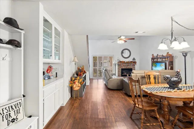 a living room with furniture a fireplace and wooden floor