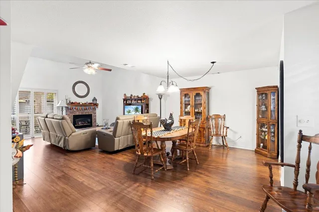 a dining room with furniture entryway and wooden floor