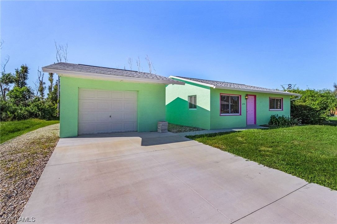 a view of a house with a yard and garage