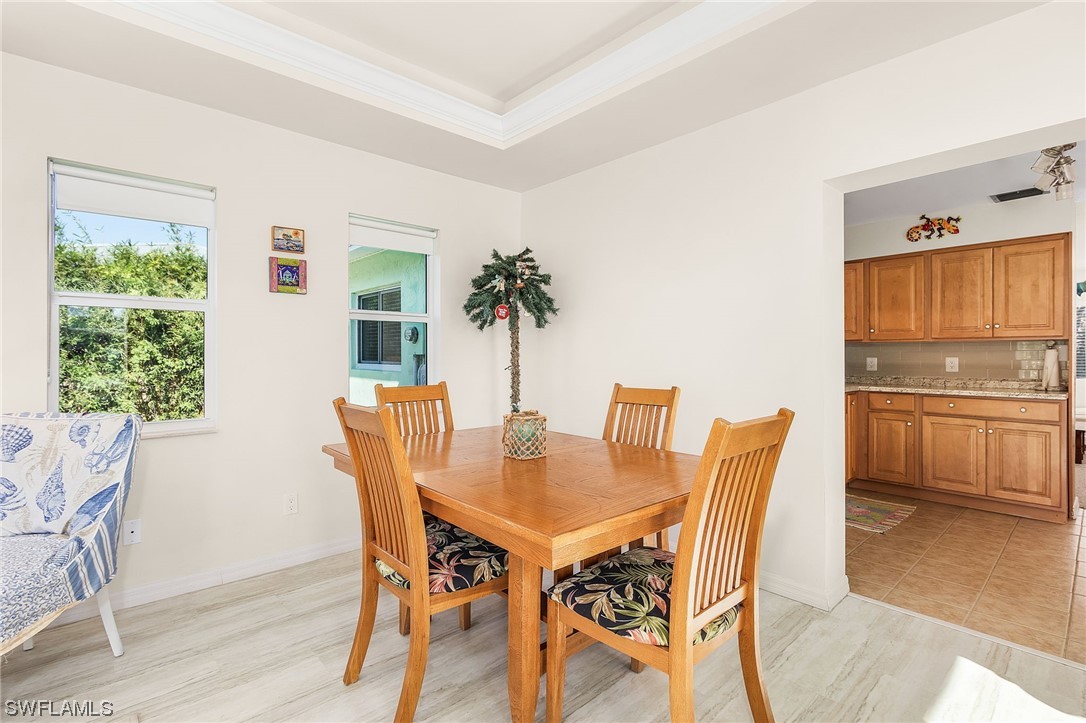 5791 Mackerel Road Bokeelia, FL 33922 - Photo 14 of 24 a view of a dining room with furniture and window