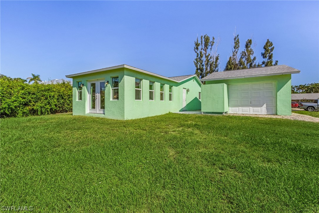 5791 Mackerel Road Bokeelia, FL 33922 - Photo 17 of 24 a view of a house with a yard