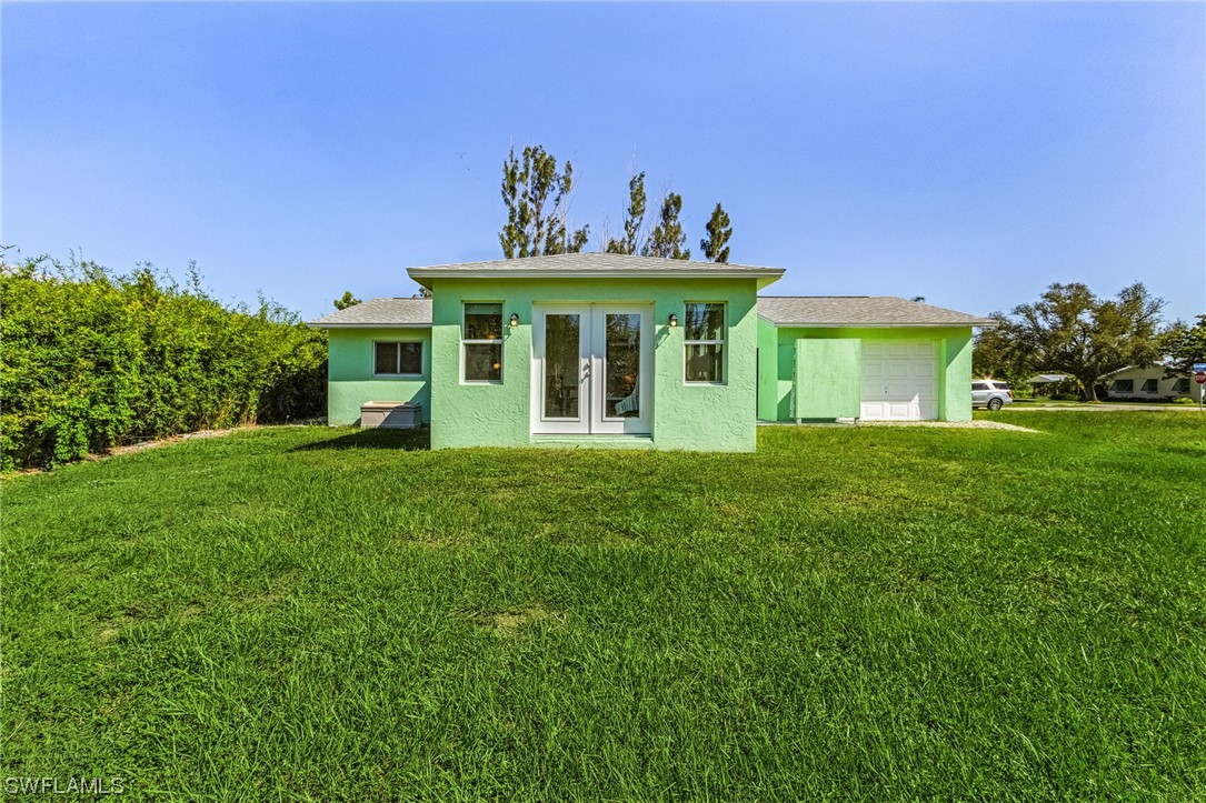 5791 Mackerel Road Bokeelia, FL 33922 - Photo 18 of 24 a front view of a house with garden