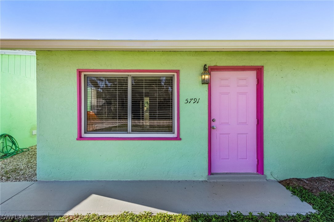 5791 Mackerel Road Bokeelia, FL 33922 - Photo 2 of 24 a front view of a house with a yard