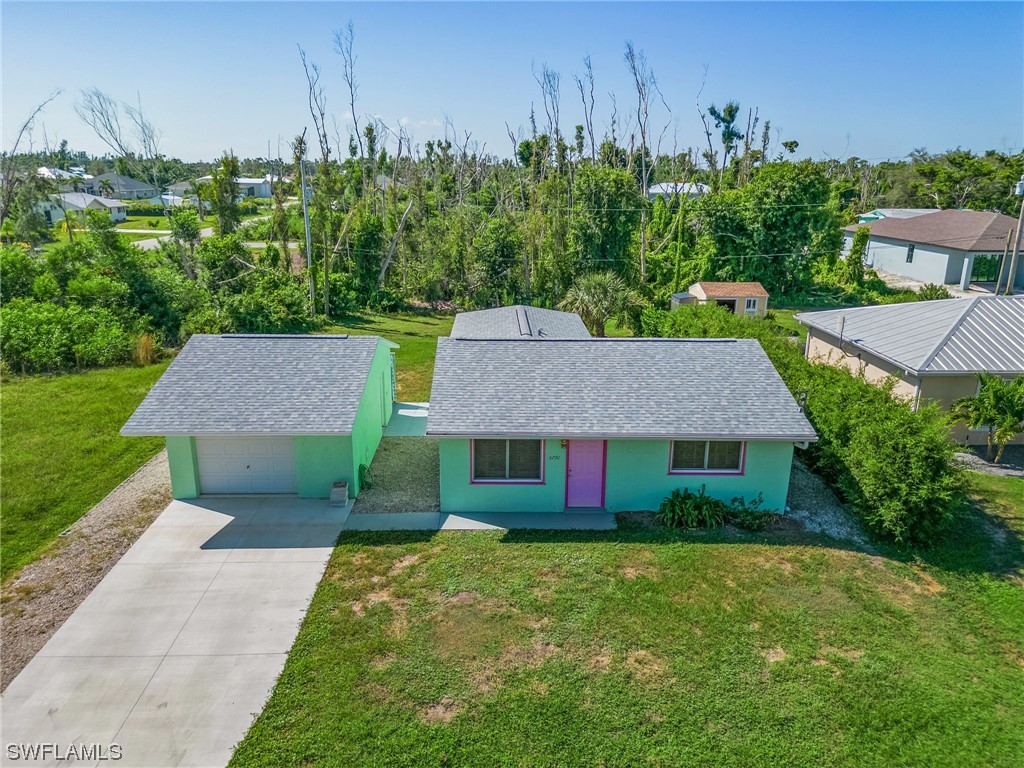 5791 Mackerel Road Bokeelia, FL 33922 - Photo 22 of 24 a view of a house with garden and a tree