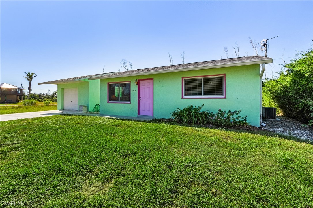 5791 Mackerel Road Bokeelia, FL 33922 - Photo 3 of 24 a view of a house with a backyard