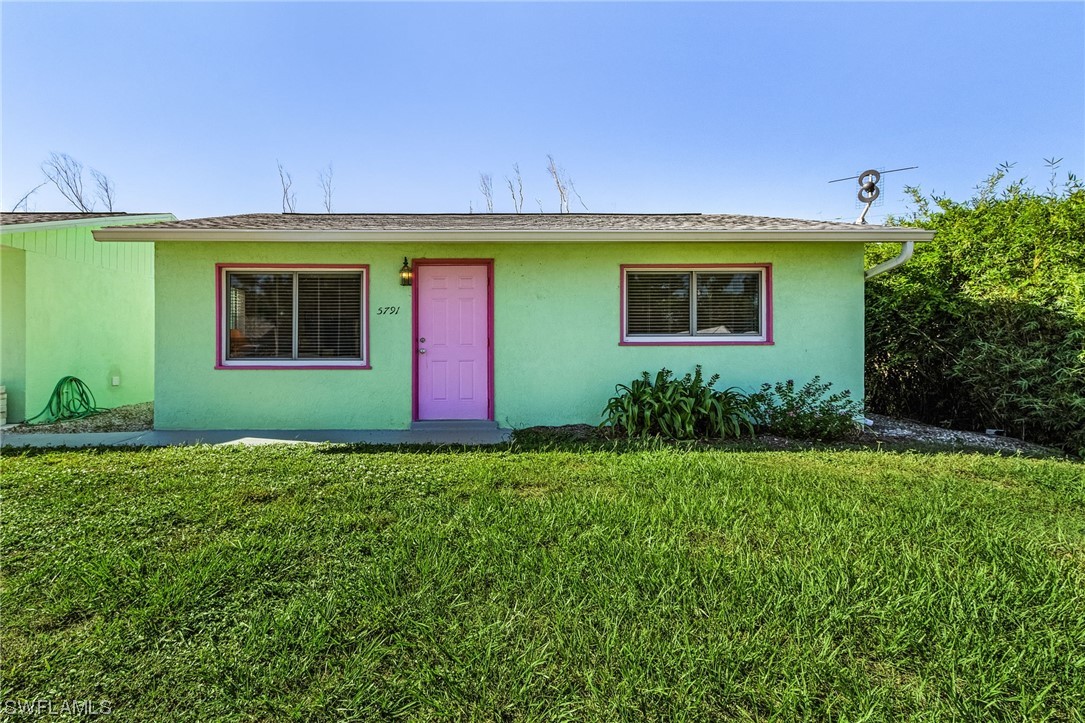 5791 Mackerel Road Bokeelia, FL 33922 - Photo 4 of 24 a front view of a house with garden