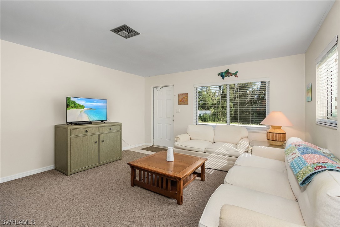 5791 Mackerel Road Bokeelia, FL 33922 - Photo 5 of 24 a living room with furniture and a window