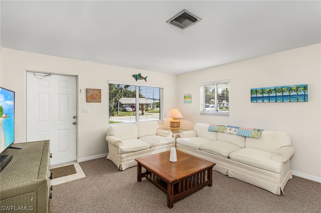 5791 Mackerel Road Bokeelia, FL 33922 - Photo 6 of 24 a living room with furniture and a table