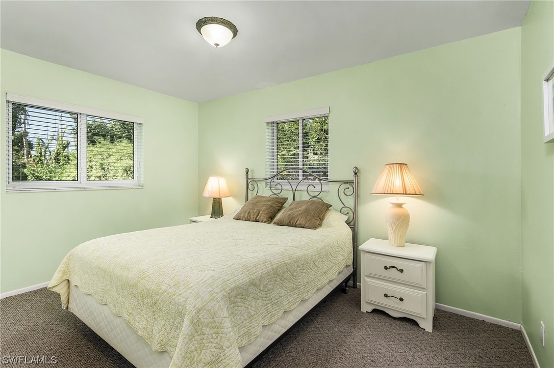 5791 Mackerel Road Bokeelia, FL 33922 - Photo 7 of 24 a bedroom with a bed and a lamp