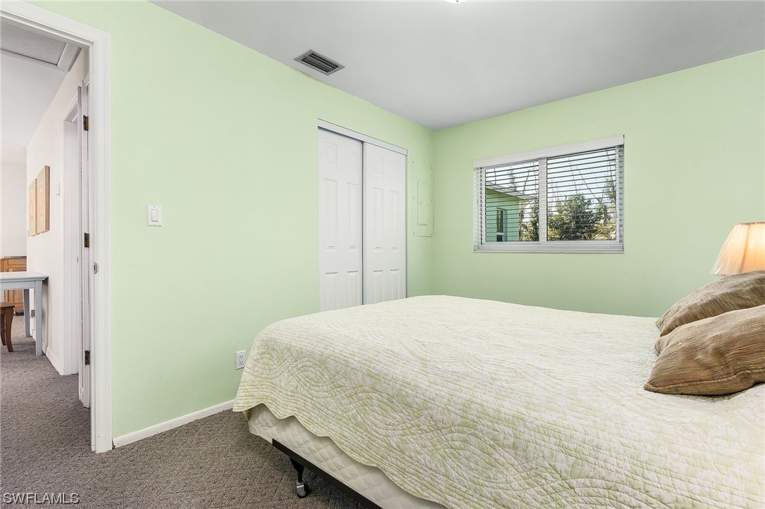 5791 Mackerel Road Bokeelia, FL 33922 - Photo 8 of 24 a bedroom with a bed and a window