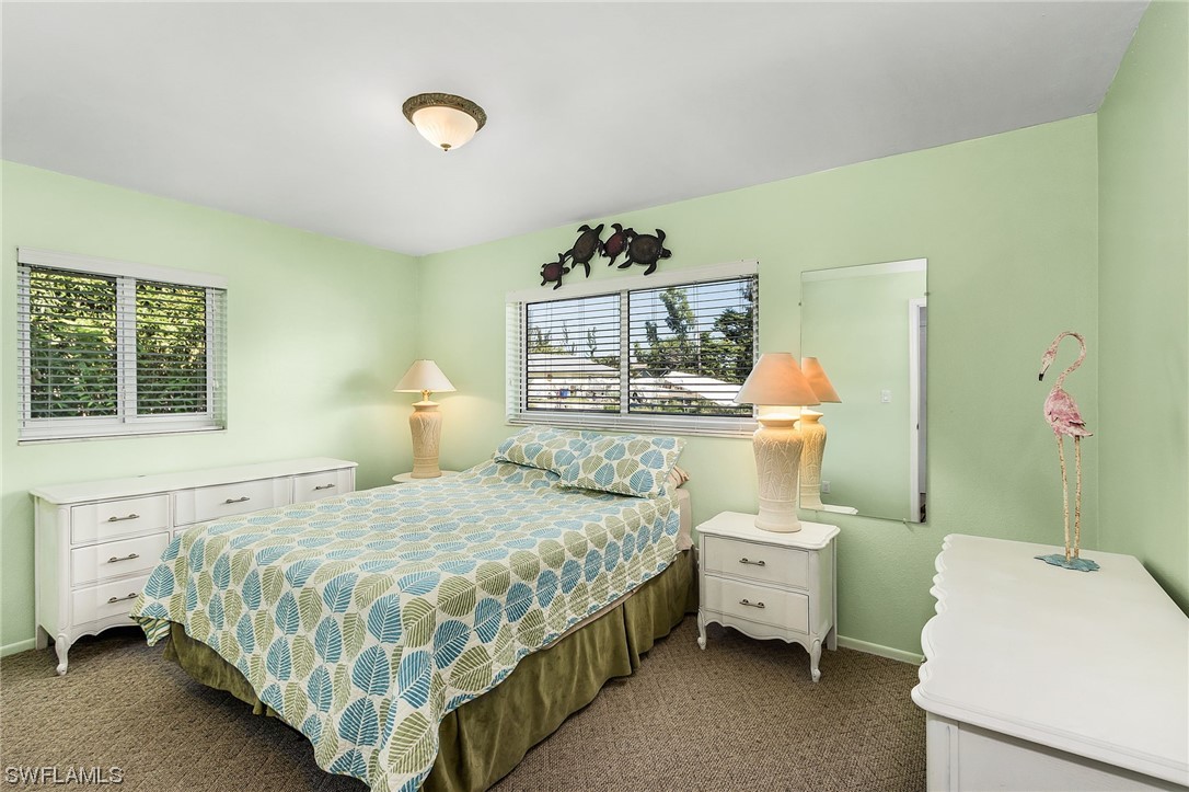 5791 Mackerel Road Bokeelia, FL 33922 - Photo 10 of 24 a bedroom with a bed and a window