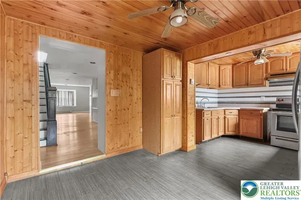 a kitchen with stainless steel appliances granite countertop a sink a stove and cabinets