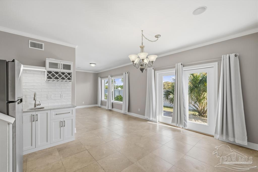 321 Gulfview Lane Perdido Key, FL 32507 - Photo 39 of 57 a view of a big room with windows and chandelier fan
