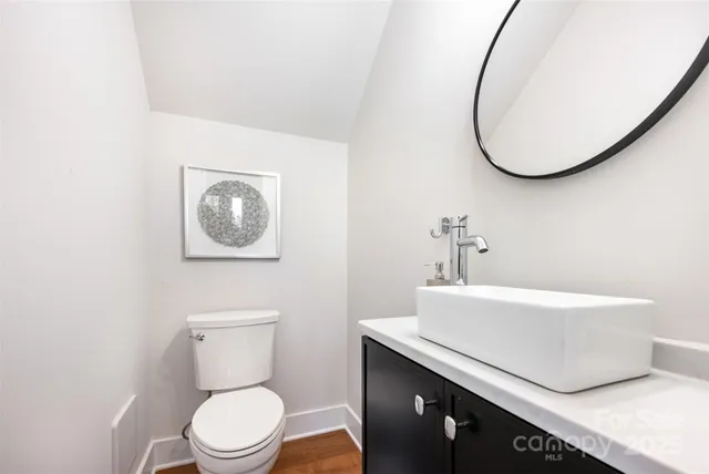 a bathroom with a sink mirror and toilet