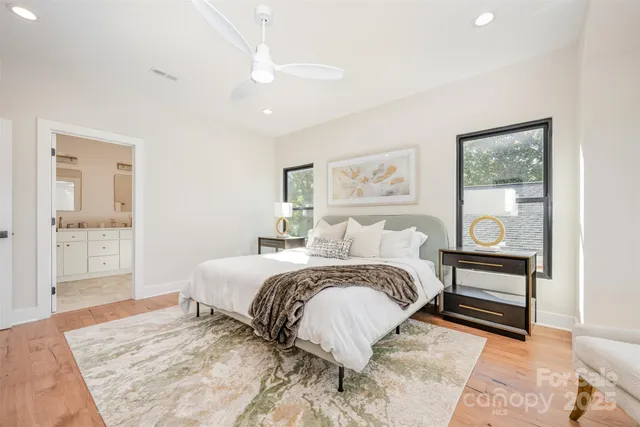 a bedroom with a large bed and a chandelier