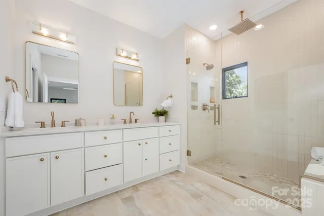 a bathroom with double sink and a mirror