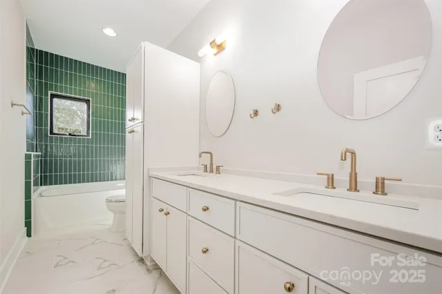 a bathroom with a sink a toilet and a mirror