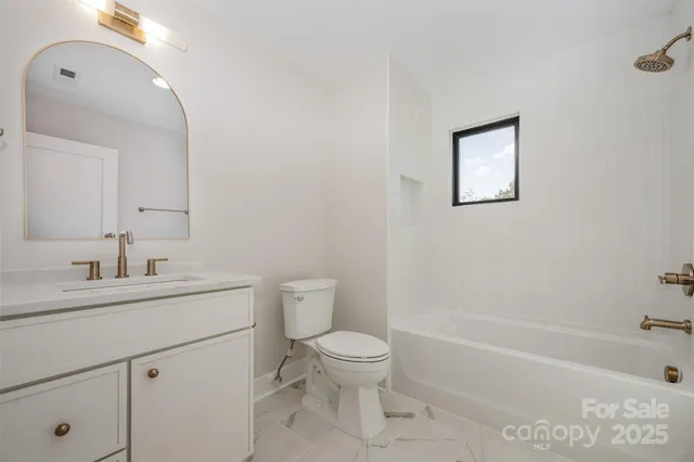 a bathroom with a toilet a sink and a bathtub