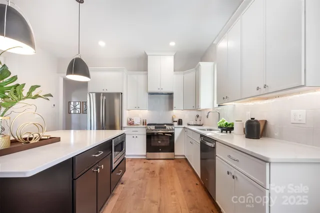 a kitchen with a sink stove and refrigerator