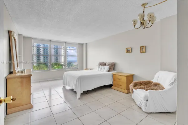 a spacious bedroom with a bed and a couch