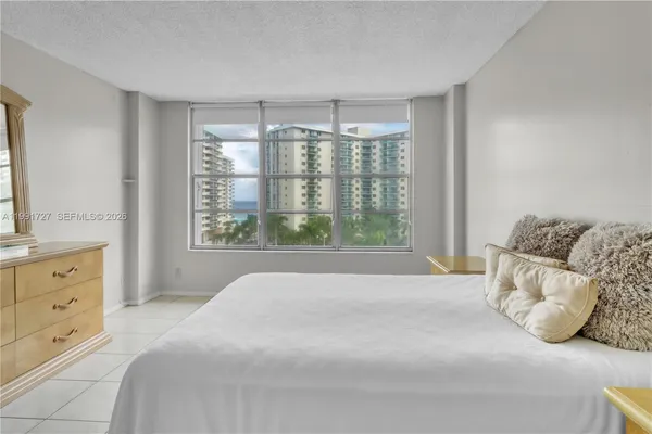 a spacious bedroom with a large bed and a window