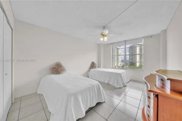 a bedroom with two beds and a window