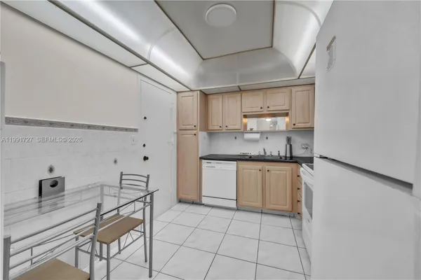 a kitchen with a sink cabinets and window
