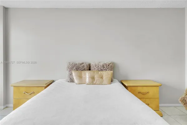 a bedroom with a bed and a tub