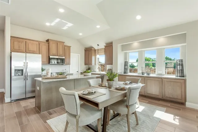 a kitchen with a table and chairs in it